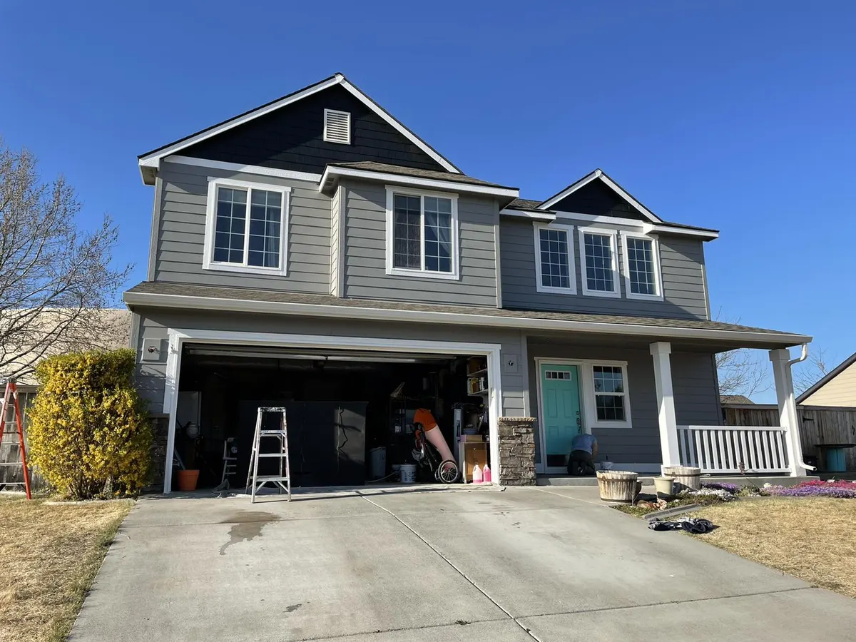 Craftsman home in Kennewick painted gray with a navy gable and white trim